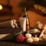 Aromatherapy oils and candles create a relaxing massage atmosphere.